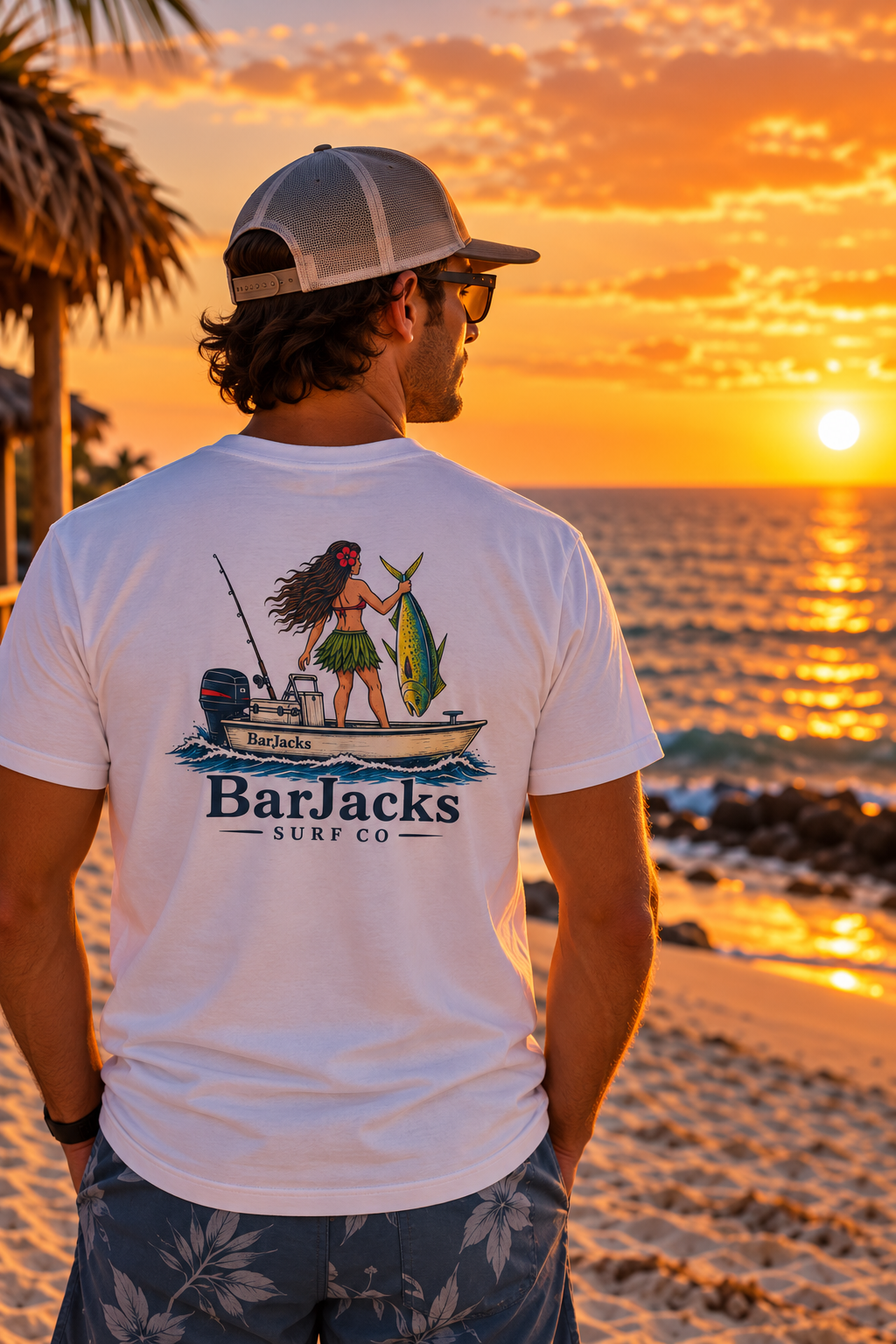 Man on the beach at sunset wearing the Bar Jacks Surf Co Hula Girl Mahi T-Shirt, back view