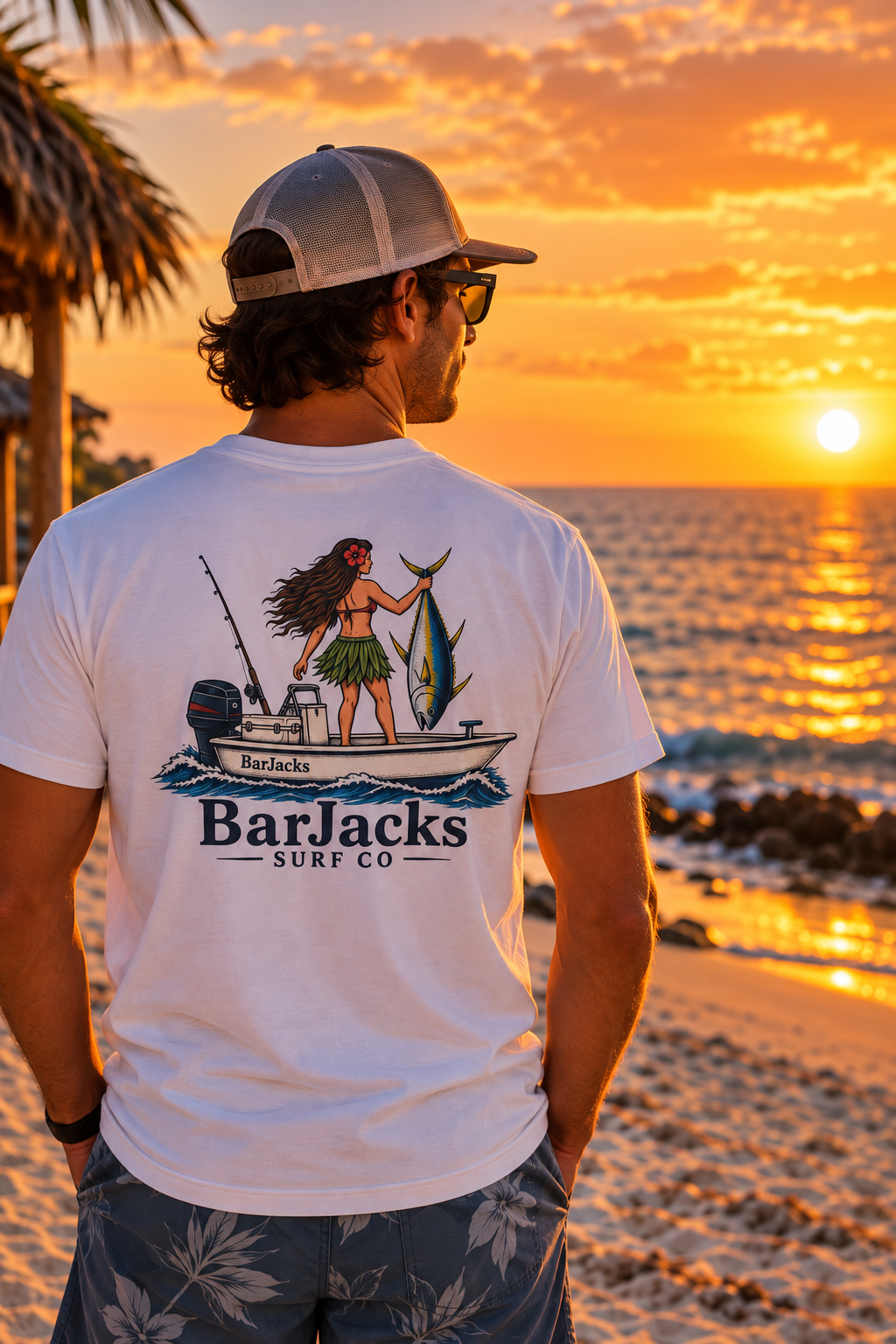 Man on the beach at sunset wearing the Bar Jacks Surf Co Hula Girl Tuna T-Shirt, back view