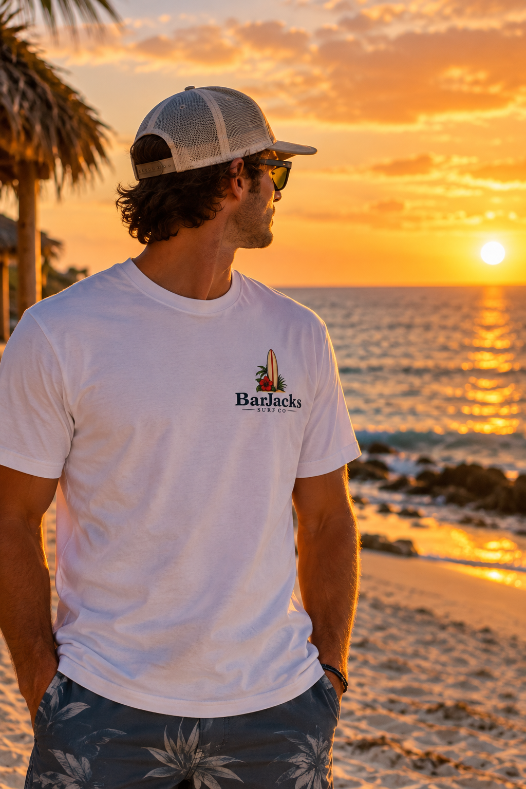Man on the beach at sunset wearing the Bar Jacks Surf Co Hula Girl Lobster T-Shirt, front view